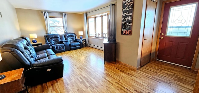 living room with light hardwood / wood-style flooring and baseboard heating