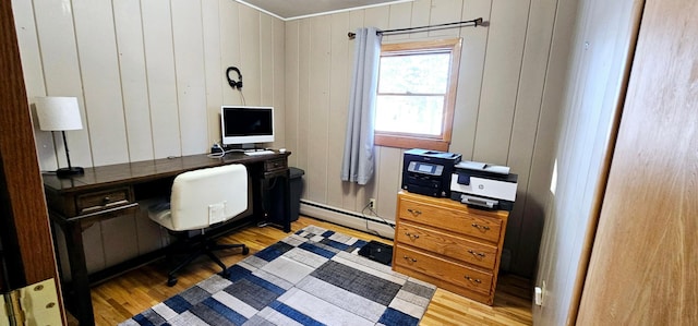 office space with baseboard heating and light hardwood / wood-style flooring