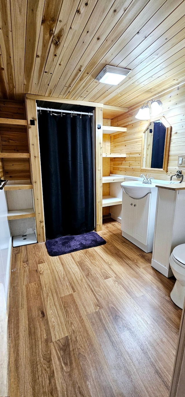 bathroom with vanity, hardwood / wood-style floors, wood ceiling, and toilet