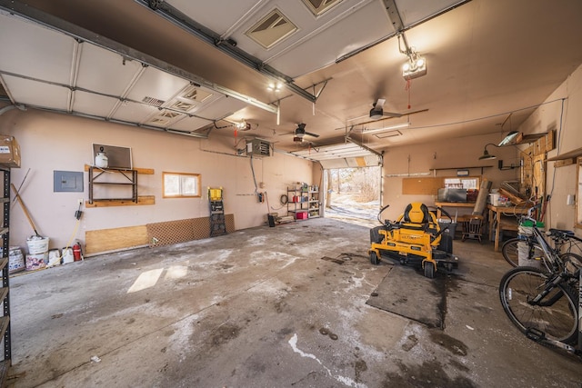 garage with a garage door opener and electric panel