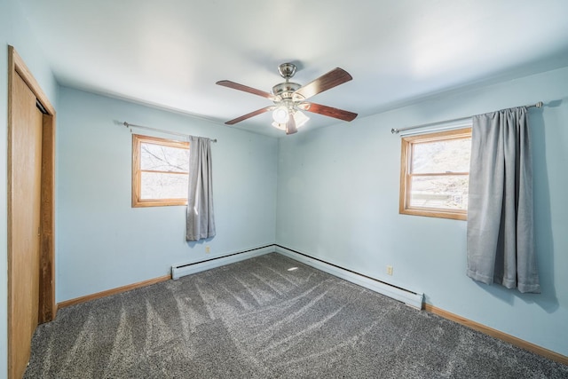 carpeted spare room featuring a ceiling fan and baseboards