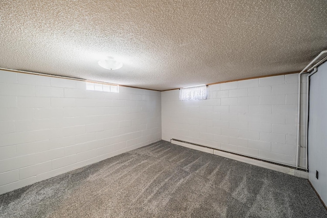 below grade area featuring concrete block wall, visible vents, a baseboard radiator, a textured ceiling, and carpet flooring