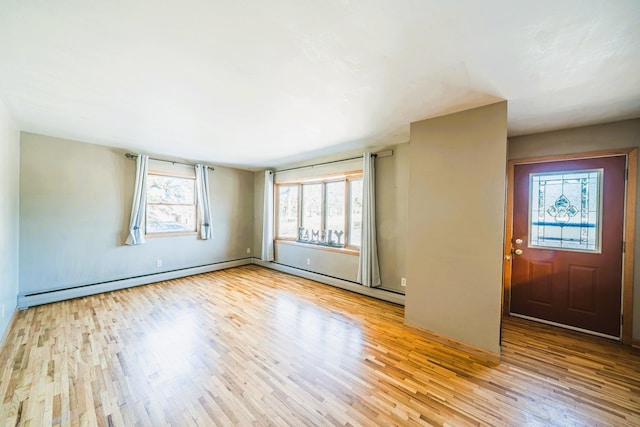 spare room featuring a baseboard radiator, a baseboard heating unit, and wood finished floors