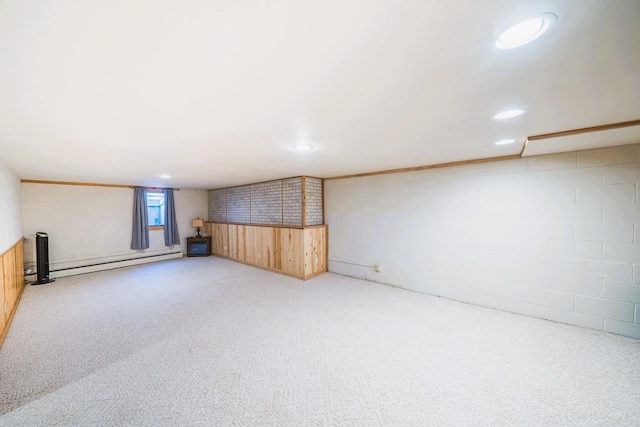 below grade area featuring a baseboard radiator, concrete block wall, carpet, and recessed lighting