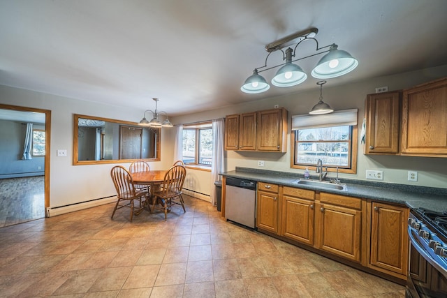 kitchen featuring dark countertops, baseboard heating, appliances with stainless steel finishes, brown cabinetry, and a sink