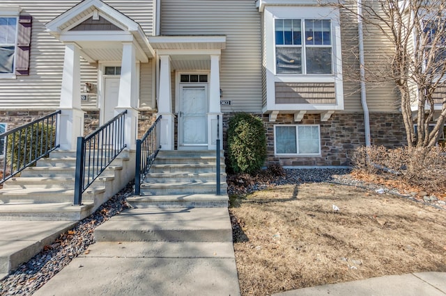 doorway to property with stone siding