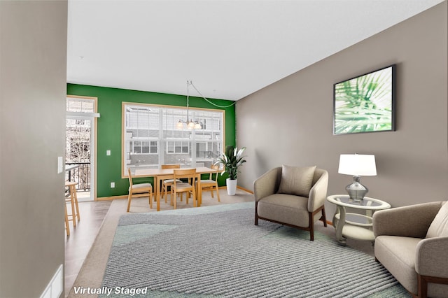 interior space featuring baseboards and a notable chandelier