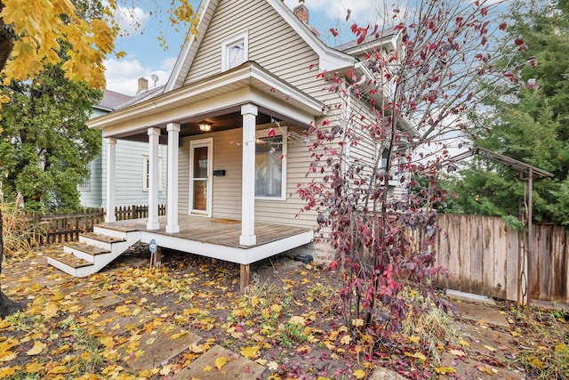 back of house featuring a porch