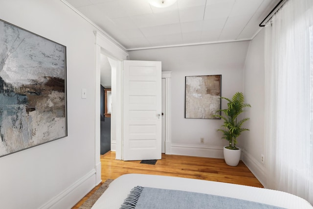 unfurnished bedroom featuring hardwood / wood-style flooring and crown molding