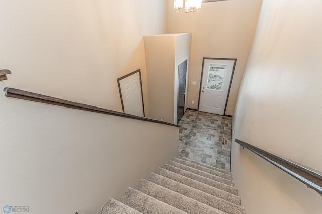 stairs with an inviting chandelier