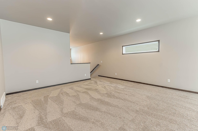 empty room featuring light carpet