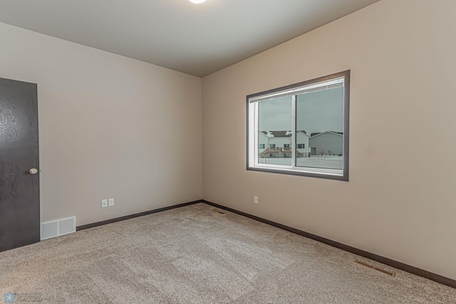 unfurnished room featuring carpet flooring