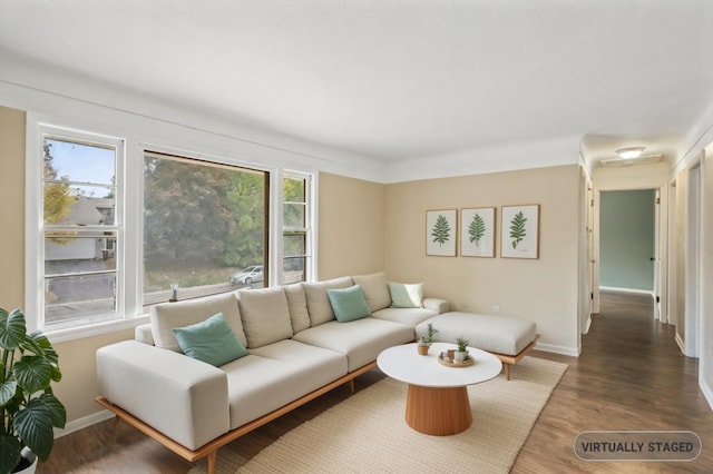 living room with dark hardwood / wood-style flooring and a healthy amount of sunlight