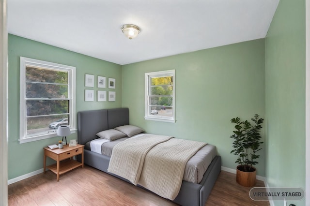 bedroom with hardwood / wood-style flooring