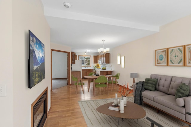 living room featuring light hardwood / wood-style flooring and a chandelier