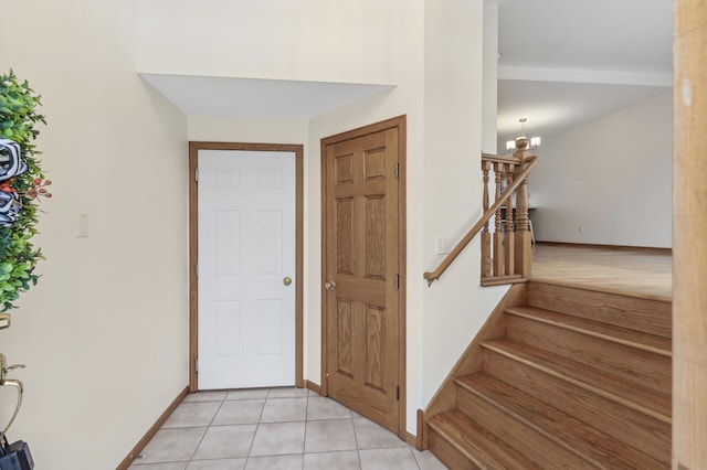 entryway featuring an inviting chandelier and light tile patterned floors