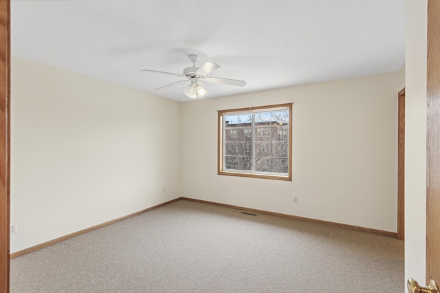 empty room featuring ceiling fan and carpet flooring