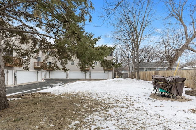 snowy yard with a garage