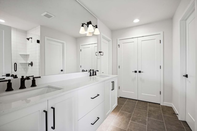 bathroom featuring an enclosed shower and vanity