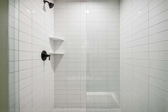 interior space featuring tiled shower