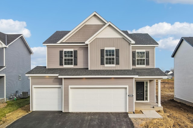 view of front of property featuring cooling unit and a garage