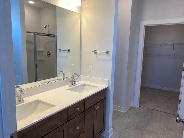 bathroom featuring an enclosed shower and vanity