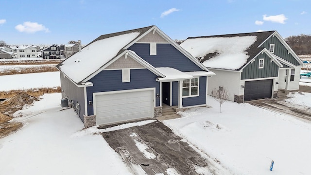 view of front of property with central AC and a garage