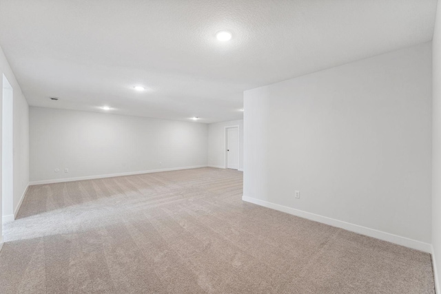 basement with light carpet and a textured ceiling