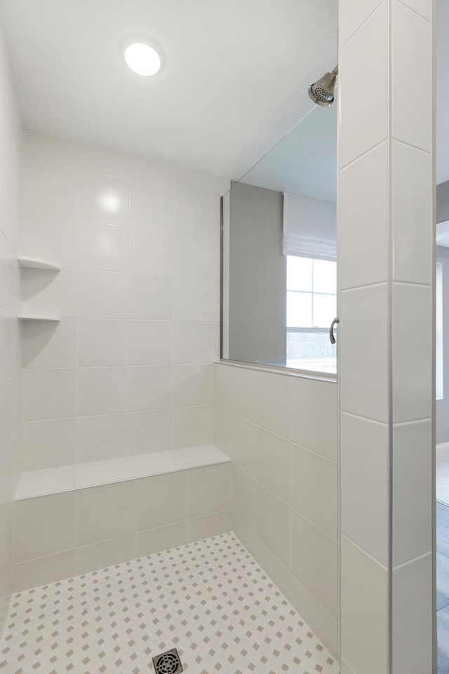 bathroom with tiled shower