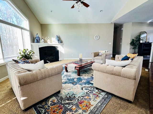 carpeted living room with ceiling fan and lofted ceiling