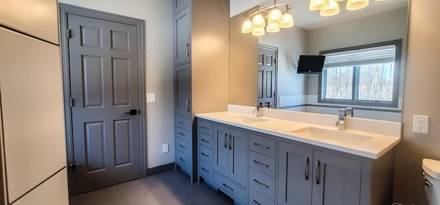 bathroom featuring toilet, tile patterned floors, and vanity