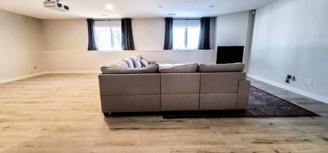 living room featuring light hardwood / wood-style floors and a wealth of natural light