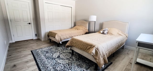 bedroom featuring light wood-type flooring and a closet