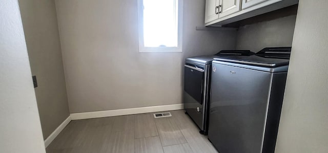 laundry area with cabinets and washer and dryer