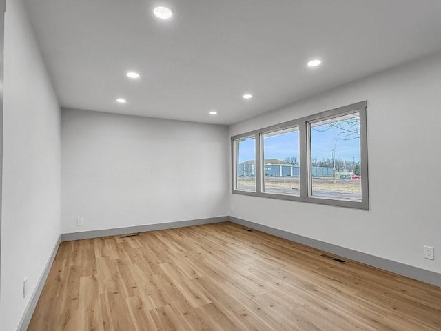 empty room with light hardwood / wood-style flooring