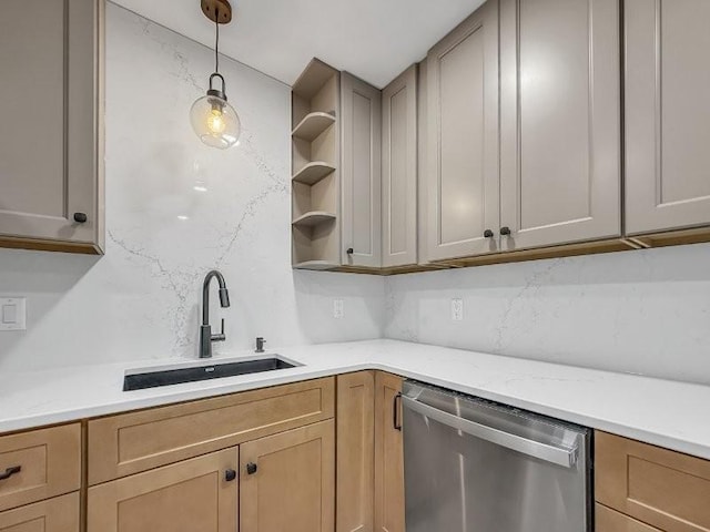 kitchen with light brown cabinetry, decorative light fixtures, dishwasher, sink, and light stone counters