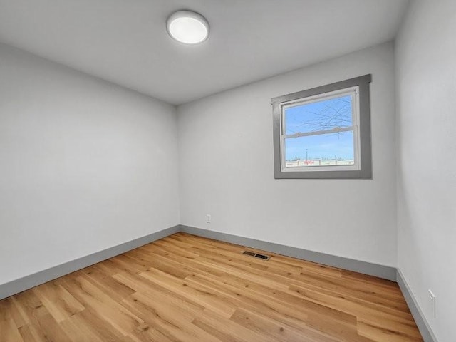 unfurnished room with hardwood / wood-style floors