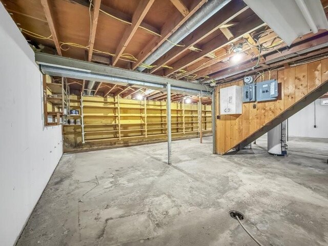 basement featuring wooden walls