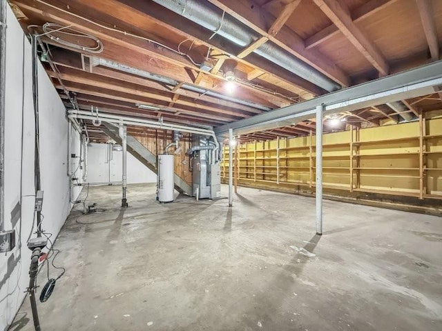 basement with water heater and heating unit