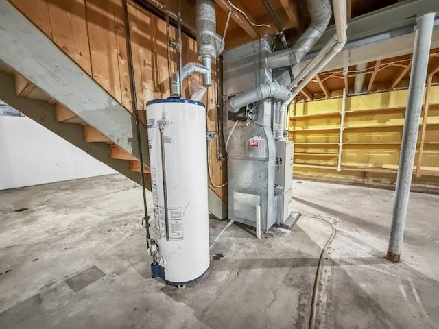 basement with water heater and heating unit