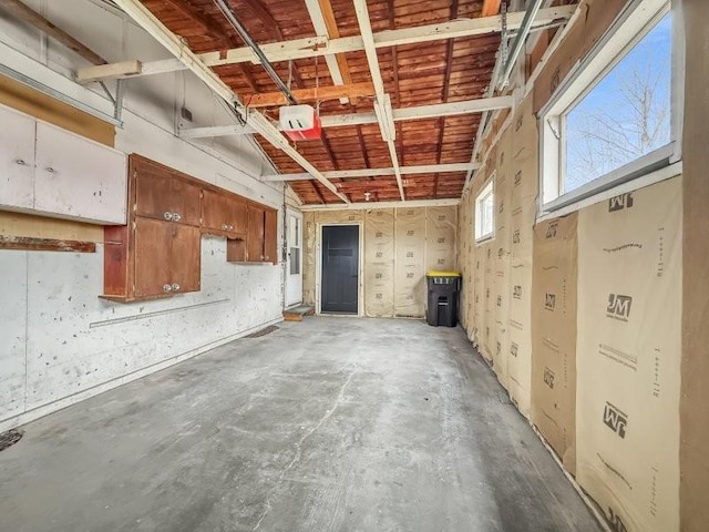 interior space featuring concrete floors and high vaulted ceiling