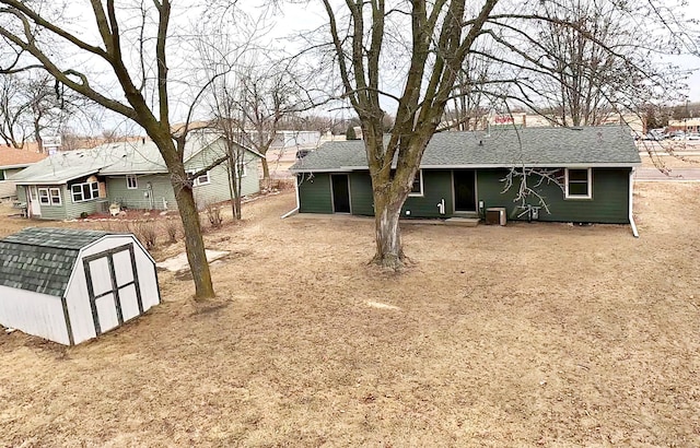 view of yard with central AC unit and a storage unit