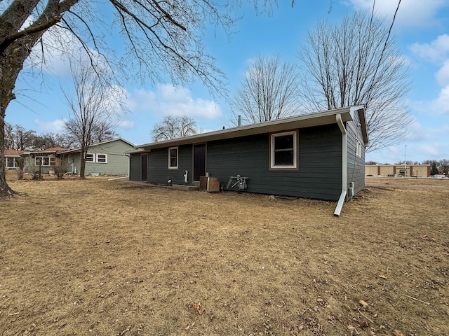 rear view of property with a yard