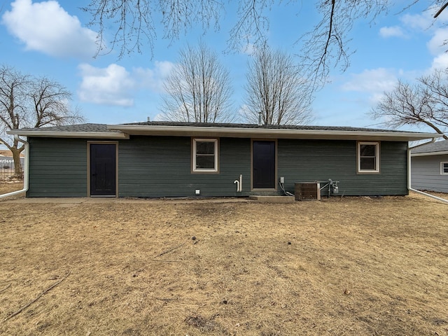 back of house featuring a yard and central air condition unit