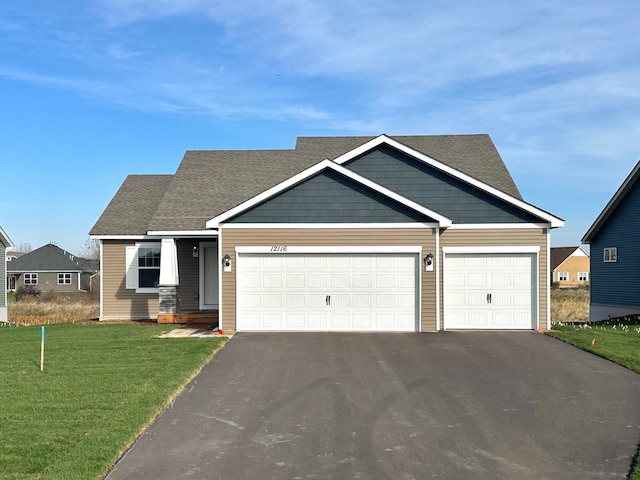 craftsman house with a front lawn and a garage