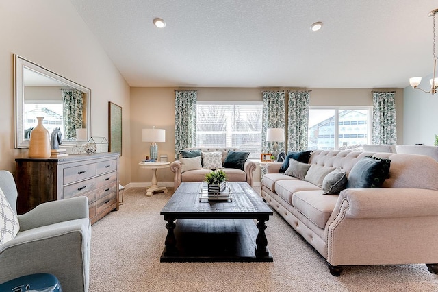 living room with light colored carpet, a textured ceiling, lofted ceiling, and a notable chandelier