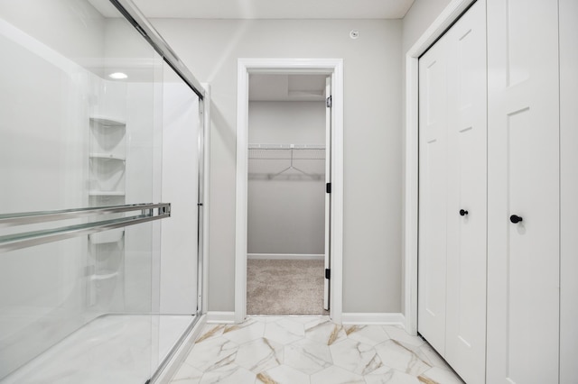 bathroom with a shower with door