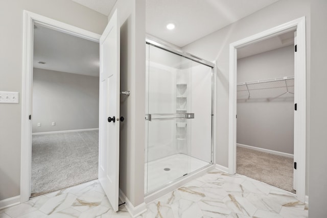 bathroom featuring a shower with door