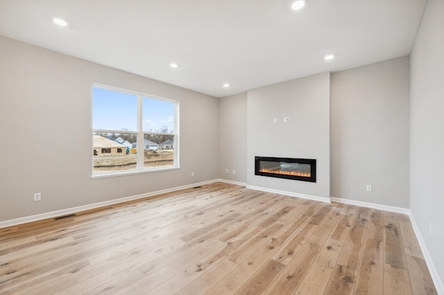 unfurnished living room with light hardwood / wood-style flooring