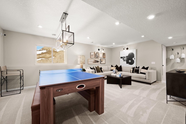 game room featuring light colored carpet and a textured ceiling